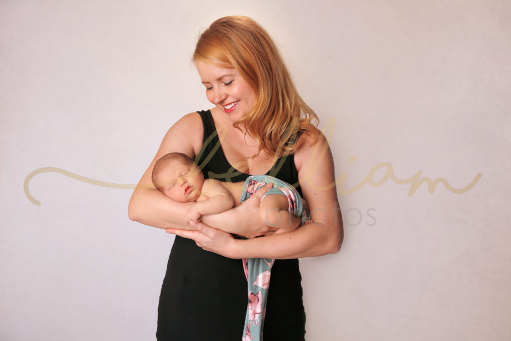 alt="newborn baby girl in moms arms"