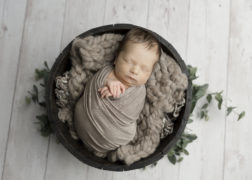 newborn baby boy in a basket
