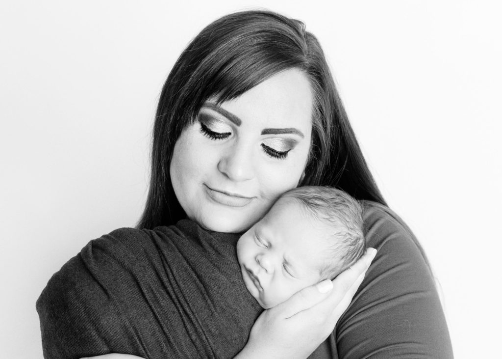 black and white photo of newborn and mom