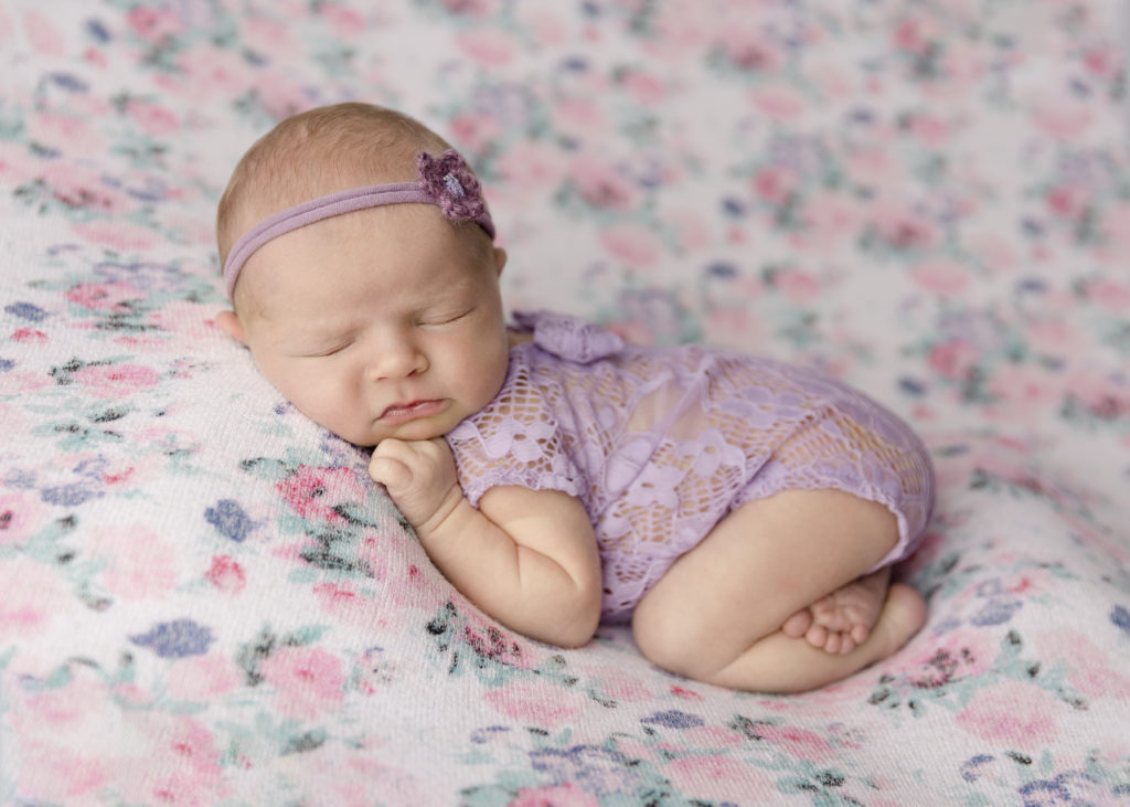 Newborn baby on a floral blanket