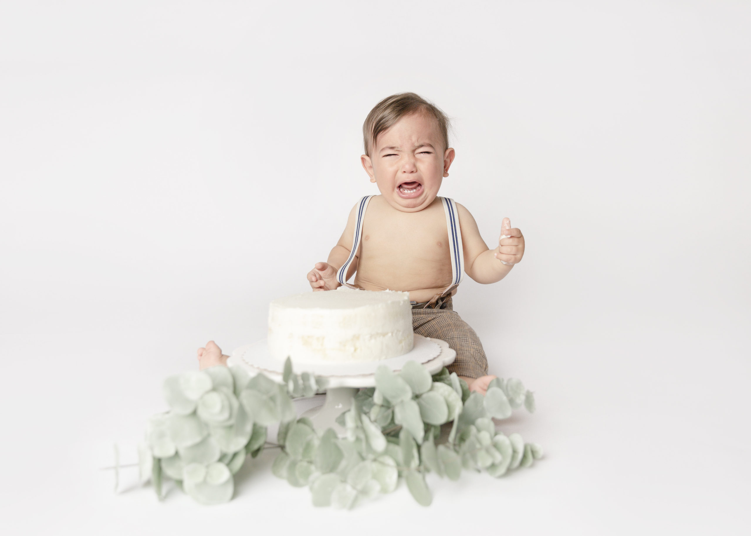 Baby boy one year old crying about his cake