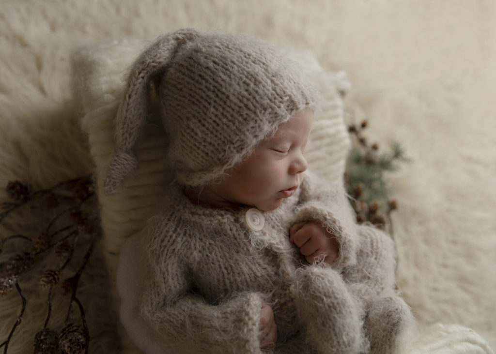 Newborn boy in a fuzzy outfit