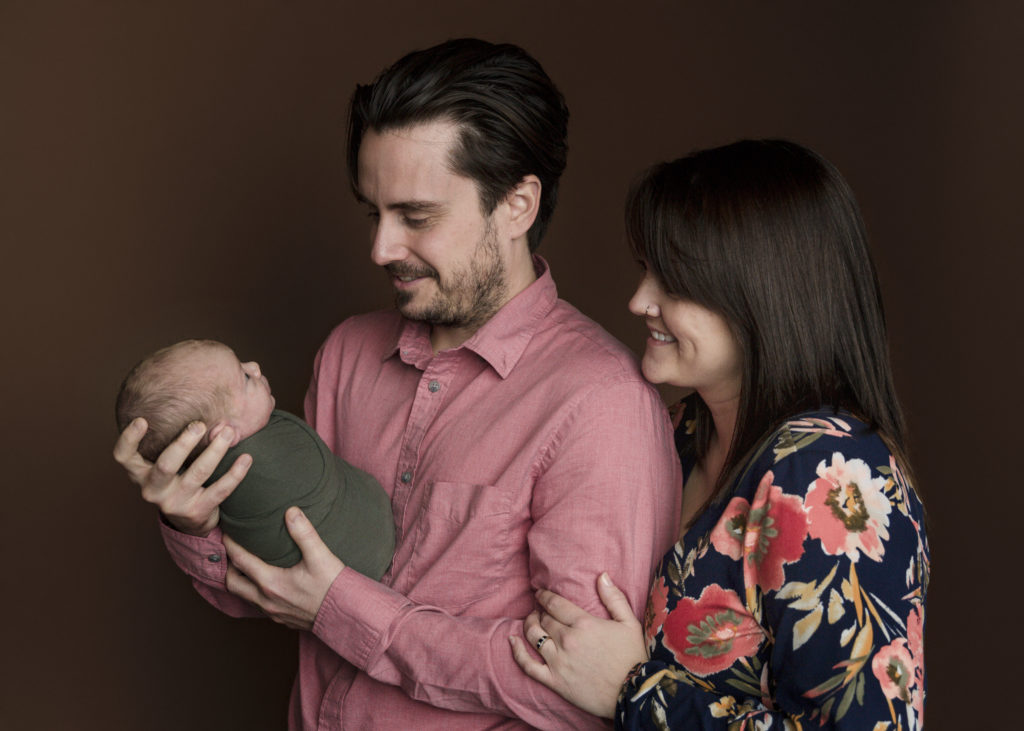 Parents holding a newborn boy