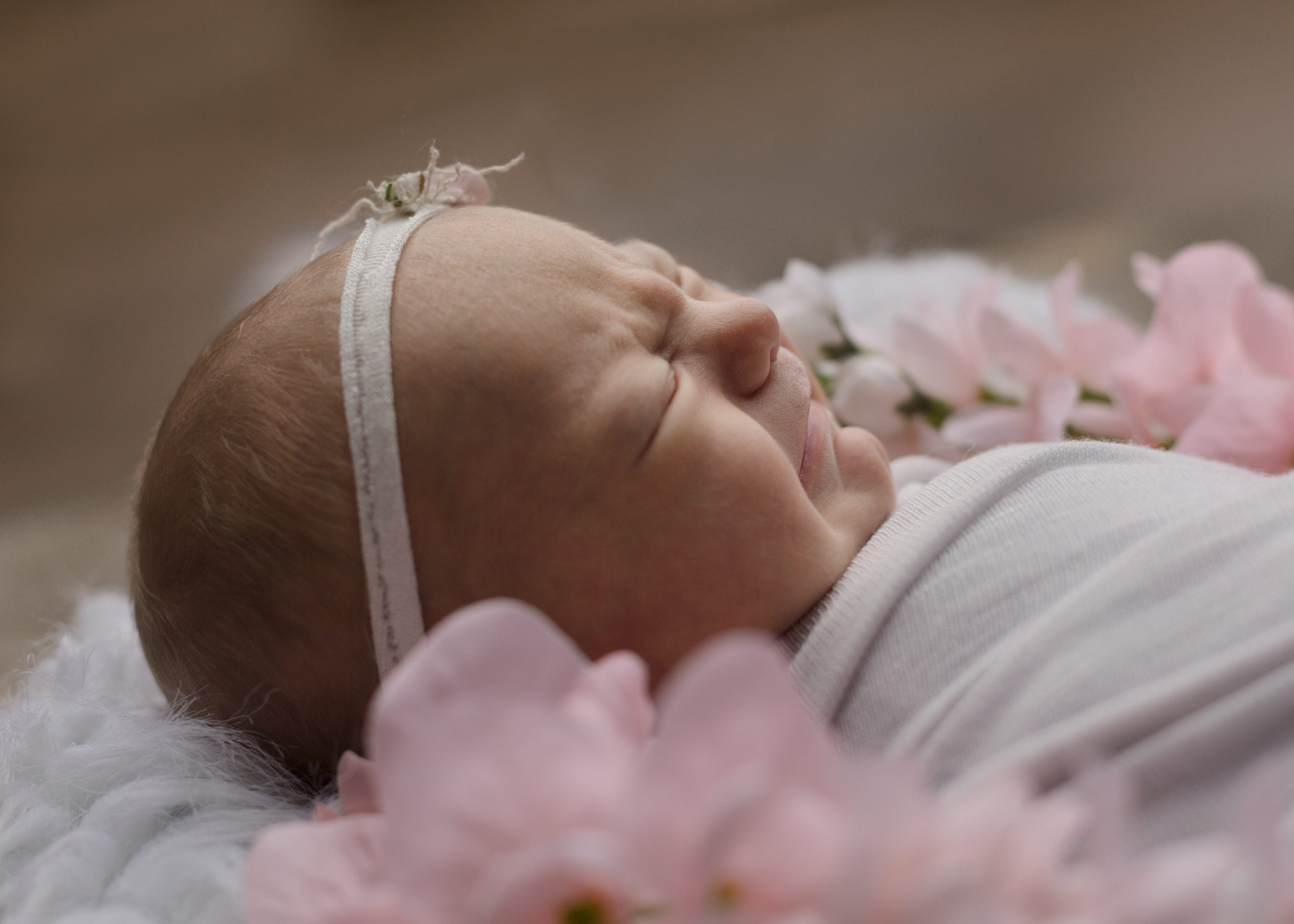 newborn baby girl in white side view