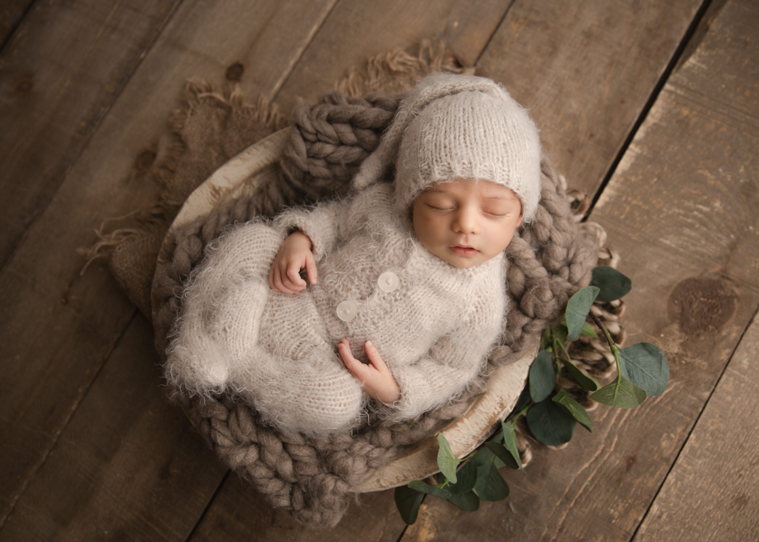 baby boy in a bowl in a wool onsie