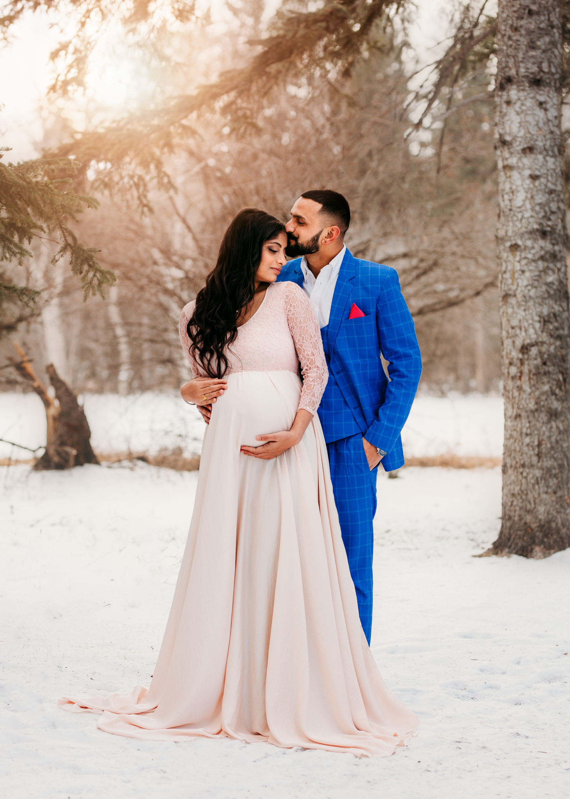 Pregnant couple cuddling outside in the winter, photography by Belliam Photos