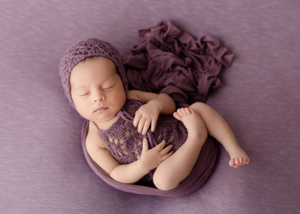 Newborn Baby in a bonnet in purple