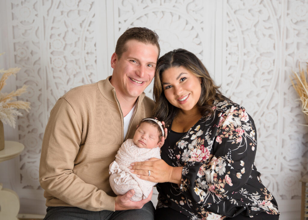 Family of three with a newborn baby girl
